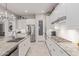 Well-lit kitchen boasts stainless steel appliances, granite countertops, and white cabinetry at 21912 E Desert Hills Dr, Queen Creek, AZ 85142