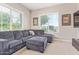 Cozy living room with a comfortable gray sectional and large windows with views at 21912 E Desert Hills Dr, Queen Creek, AZ 85142