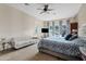 Spacious bedroom features a ceiling fan, en suite bathroom, and a decorative sitting area at 21912 E Desert Hills Dr, Queen Creek, AZ 85142