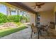 Covered patio overlooking lush landscaping and water feature for relaxation or entertaining at 21912 E Desert Hills Dr, Queen Creek, AZ 85142