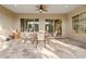 Covered patio with tiled flooring and outdoor dining set with chairs, perfect for entertaining or relaxing outdoors at 21912 E Desert Hills Dr, Queen Creek, AZ 85142