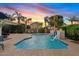 Inviting backyard pool with a rock waterfall and serene lounge area at 21912 E Desert Hills Dr, Queen Creek, AZ 85142