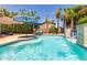 Backyard pool featuring sparkling water, lush landscaping, and patio umbrellas at 21912 E Desert Hills Dr, Queen Creek, AZ 85142