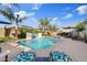Relaxing backyard pool with a waterfall, surrounded by lush greenery and lounge chairs, perfect for enjoying sunny days at 21912 E Desert Hills Dr, Queen Creek, AZ 85142