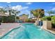 Sparkling backyard pool with a waterfall feature, offering a refreshing oasis surrounded by mature landscaping and lounge chairs at 21912 E Desert Hills Dr, Queen Creek, AZ 85142