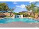 Beautiful backyard pool with a stone waterfall feature, surrounded by lush landscaping and clear blue skies at 21912 E Desert Hills Dr, Queen Creek, AZ 85142