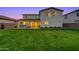 The exterior of the home boasts a covered patio and expansive backyard with lush grass, perfect for outdoor enjoyment at 22870 E Sonoqui Blvd, Queen Creek, AZ 85142