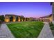 Large, well-maintained backyard with pavers, lush grass, and privacy landscaping creating a serene retreat at 22870 E Sonoqui Blvd, Queen Creek, AZ 85142