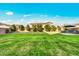 A large manicured lawn is surrounded by mature landscaping, creating a private backyard oasis at 22870 E Sonoqui Blvd, Queen Creek, AZ 85142