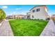 Lush backyard with an outdoor kitchen and stone pathway enhances this outdoor oasis at 22870 E Sonoqui Blvd, Queen Creek, AZ 85142