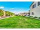 A well manicured yard with beautiful green grass and tasteful landscaping is great for outdoor activities at 22870 E Sonoqui Blvd, Queen Creek, AZ 85142