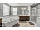 Bathroom features a soaking tub, double vanity, and a glass-enclosed shower at 22870 E Sonoqui Blvd, Queen Creek, AZ 85142