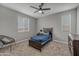 This cozy bedroom features a ceiling fan, natural light, and carpeted floors at 22870 E Sonoqui Blvd, Queen Creek, AZ 85142