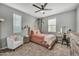 Comfortable bedroom featuring plush carpet, neutral walls, ceiling fan, and ample natural light at 22870 E Sonoqui Blvd, Queen Creek, AZ 85142