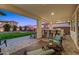 Outdoor living space features a covered patio, built-in bar, and an expansive backyard at 22870 E Sonoqui Blvd, Queen Creek, AZ 85142