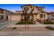 Inviting two-story home with a well-manicured lawn, front porch, and an attached two-car garage at 22870 E Sonoqui Blvd, Queen Creek, AZ 85142
