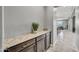 Stylish hallway with granite countertop, dark wood cabinets, and views into the dining area at 22870 E Sonoqui Blvd, Queen Creek, AZ 85142