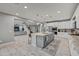 Open concept kitchen with stainless steel appliances, an island, and easy access to the living room at 22870 E Sonoqui Blvd, Queen Creek, AZ 85142