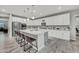 Beautiful kitchen featuring a granite island with seating, white cabinets, and stainless steel appliances at 22870 E Sonoqui Blvd, Queen Creek, AZ 85142