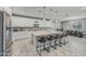Spacious kitchen featuring white cabinets, stainless steel appliances, and a large center island with seating at 22870 E Sonoqui Blvd, Queen Creek, AZ 85142