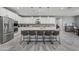 Bright kitchen boasts a large island with seating, stainless steel appliances, and ample white cabinetry at 22870 E Sonoqui Blvd, Queen Creek, AZ 85142