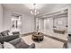 Open-concept living area with hardwood floors, neutral walls, elegant furniture, and modern lighting at 22870 E Sonoqui Blvd, Queen Creek, AZ 85142