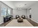 Spacious living room with hardwood floors, neutral walls, piano, modern furnishings, and natural light at 22870 E Sonoqui Blvd, Queen Creek, AZ 85142