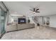 Open living room with tiled floors, media center, ceiling fan and view of staircase at 22870 E Sonoqui Blvd, Queen Creek, AZ 85142