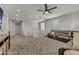Upstairs loft with neutral carpet, comfortable leather sofa, and modern entertainment center at 22870 E Sonoqui Blvd, Queen Creek, AZ 85142