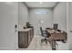 Functional home office with a modern desk, cabinetry, and natural light for a productive workspace at 22870 E Sonoqui Blvd, Queen Creek, AZ 85142