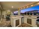Covered outdoor kitchen boasts stainless steel appliances, ample counter space, and backyard views at 22870 E Sonoqui Blvd, Queen Creek, AZ 85142