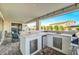 An outdoor kitchen with stainless steel drawers and appliances is the perfect place to relax and dine at 22870 E Sonoqui Blvd, Queen Creek, AZ 85142