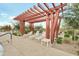 Poolside pergola with lounge chairs and tables offers a perfect spot for relaxation and shade at 22870 E Sonoqui Blvd, Queen Creek, AZ 85142