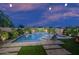 Well-lit backyard with pool, spa, lush landscaping, and stone paver patio at 2339 E Questa Dr, Phoenix, AZ 85024