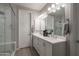 Bright bathroom with double vanity, full mirror and tiled glass shower enclosure at 2339 E Questa Dr, Phoenix, AZ 85024