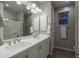 Bright bathroom with a double sink vanity, large mirror, and glass enclosed shower at 2339 E Questa Dr, Phoenix, AZ 85024
