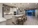 Bright kitchen featuring stainless steel appliances, a large island with seating, and sliding glass doors to the pool at 2339 E Questa Dr, Phoenix, AZ 85024
