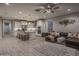 Open-concept kitchen and living area featuring an island with seating, stainless steel appliances, and hardwood floors at 2339 E Questa Dr, Phoenix, AZ 85024