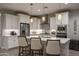 Modern kitchen featuring stainless steel appliances, white cabinets, and a large island with bar seating at 2339 E Questa Dr, Phoenix, AZ 85024