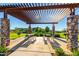 Shaded picnic area with stone columns, tables, and view of the playground, ideal for gatherings with neighbors at 2339 E Questa Dr, Phoenix, AZ 85024