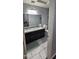 Bathroom with double sink vanity, granite countertops, and tiled floors at 23630 W Chambers St, Buckeye, AZ 85326