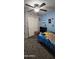 Cozy bedroom with carpet, ceiling fan, and closet with a closet organizer at 23630 W Chambers St, Buckeye, AZ 85326