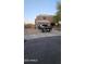 Charming two-story home with attached garage and gravel front yard and a black truck parked in the driveway at 23630 W Chambers St, Buckeye, AZ 85326