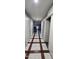 Long hallway with unique tile flooring and neutral paint, connecting the different areas of the home at 23630 W Chambers St, Buckeye, AZ 85326