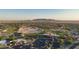 Aerial view of the community and golf course with mountain views in the distance at 2401 E Antigua Dr, Casa Grande, AZ 85194