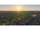 Aerial view of a neighborhood with golf course at sunset at 2401 E Antigua Dr, Casa Grande, AZ 85194
