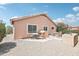 Charming backyard with gravel, patio and outdoor seating under a clear blue sky at 2401 E Antigua Dr, Casa Grande, AZ 85194