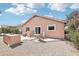 Landscaped backyard with patio seating and desert shrubbery at 2401 E Antigua Dr, Casa Grande, AZ 85194