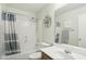 Cozy bathroom featuring single sink, framed mirror, updated lighting, and a shower-tub combo at 2401 E Antigua Dr, Casa Grande, AZ 85194