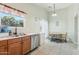 Well-lit kitchen and dining area featuring tile floors, updated appliances, and ample counter space at 2401 E Antigua Dr, Casa Grande, AZ 85194